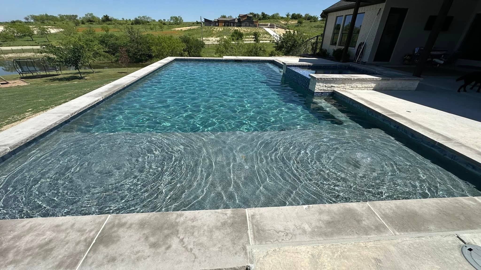 Modern rectangular pool with a broad view across the water