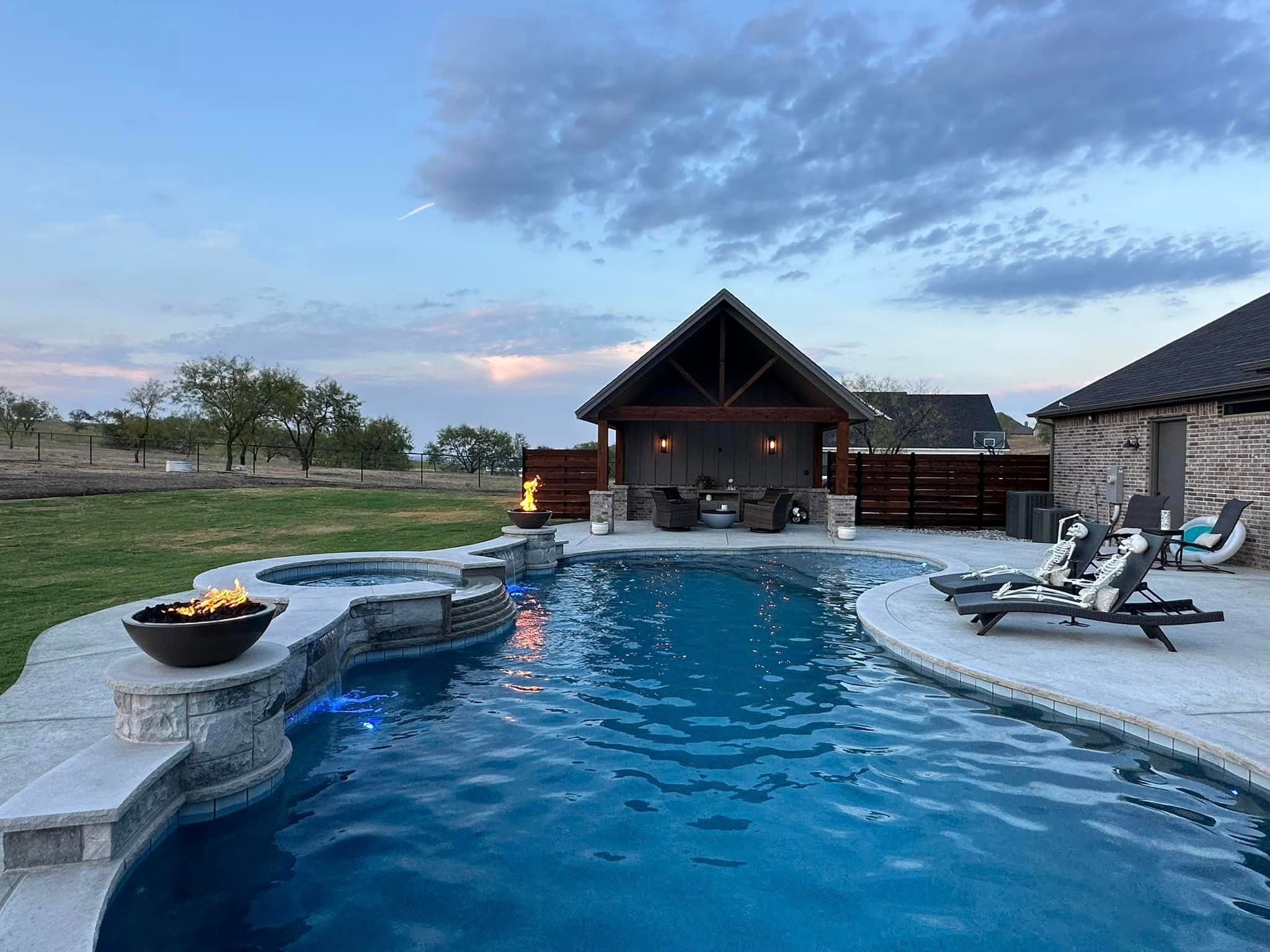 Pool and pavilion at dusk with glowing water features