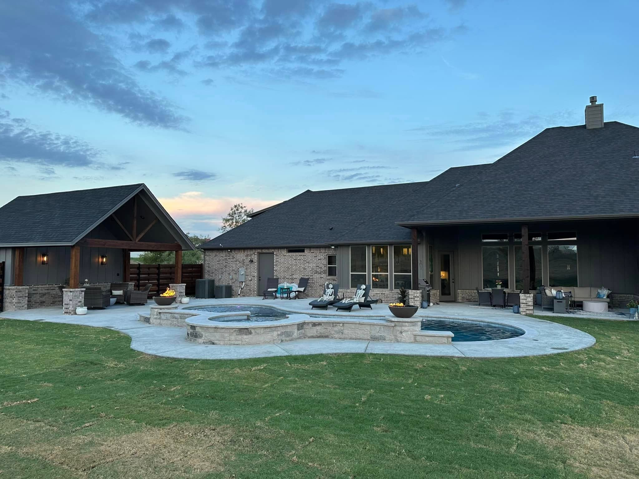 Completed backyard pool and pavilion at blue hour