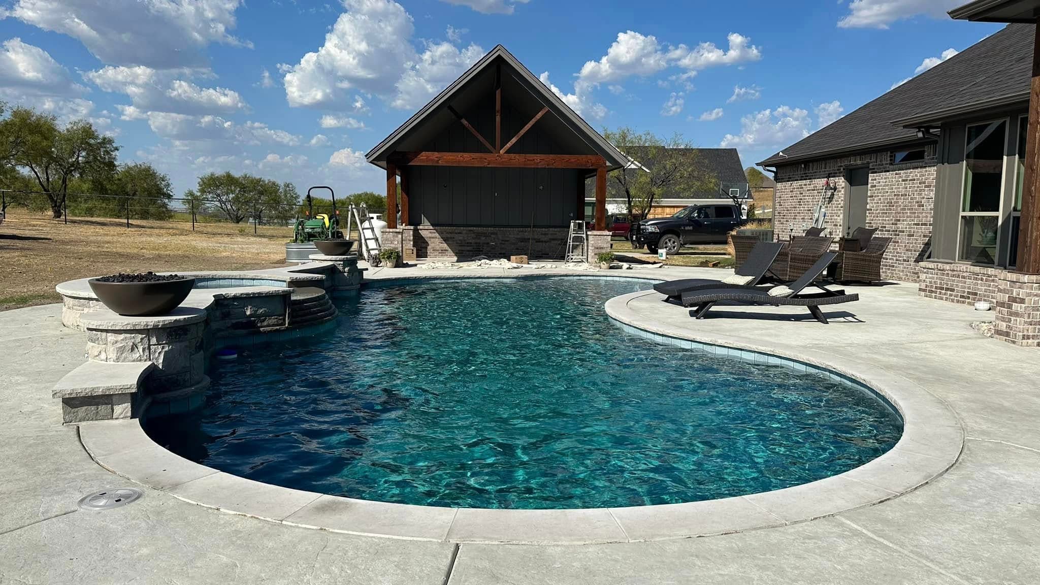 Finished pool with a raised spa and open-air pavilion