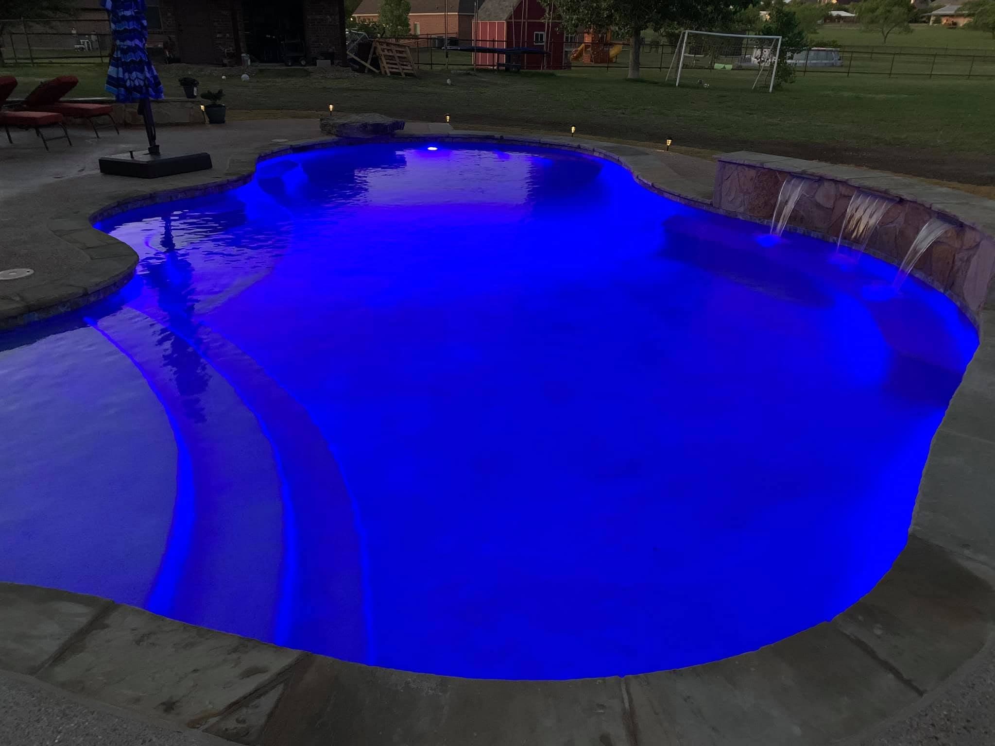 Finished pool with curved steps, raised spa, and coordinated stonework